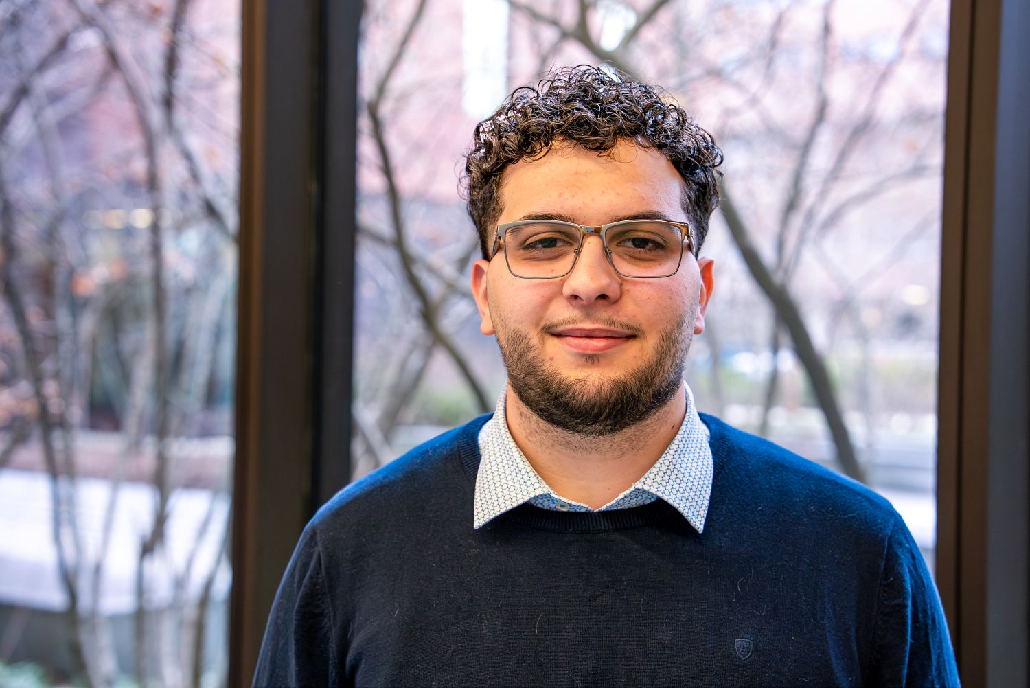 Neil Chaoui ‘26 (CAHNR), an allied health sciences major poses for a photo in Susan Herbst Hall (SHH).