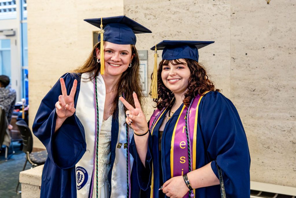 Two female students pose before CAHNR commencement