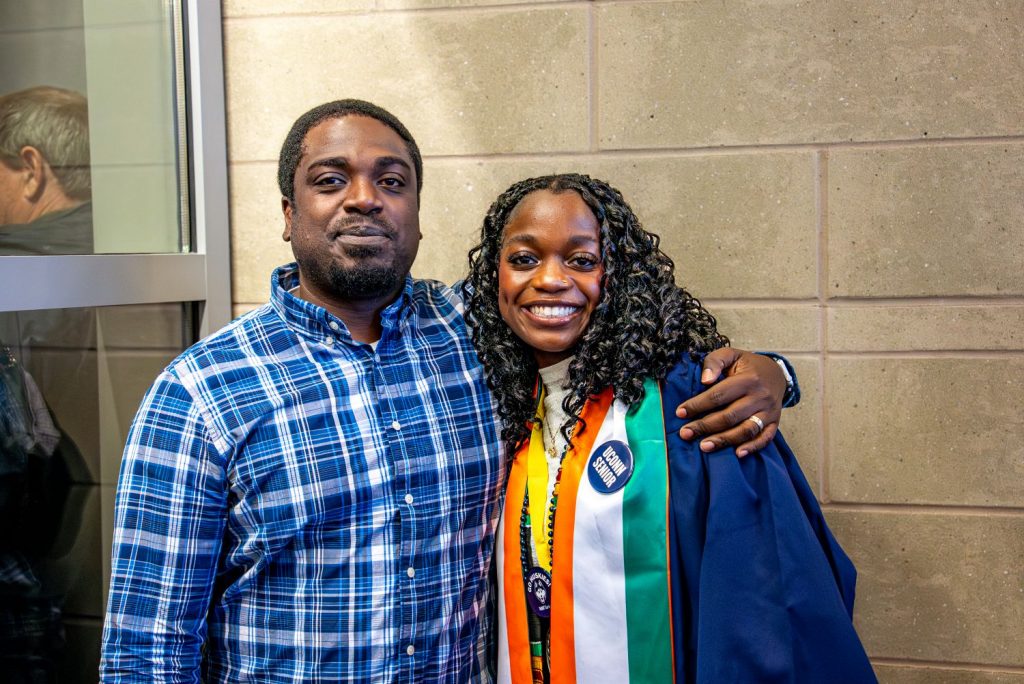 Man and female graduate pose before 2026 CAHNR Commencement
