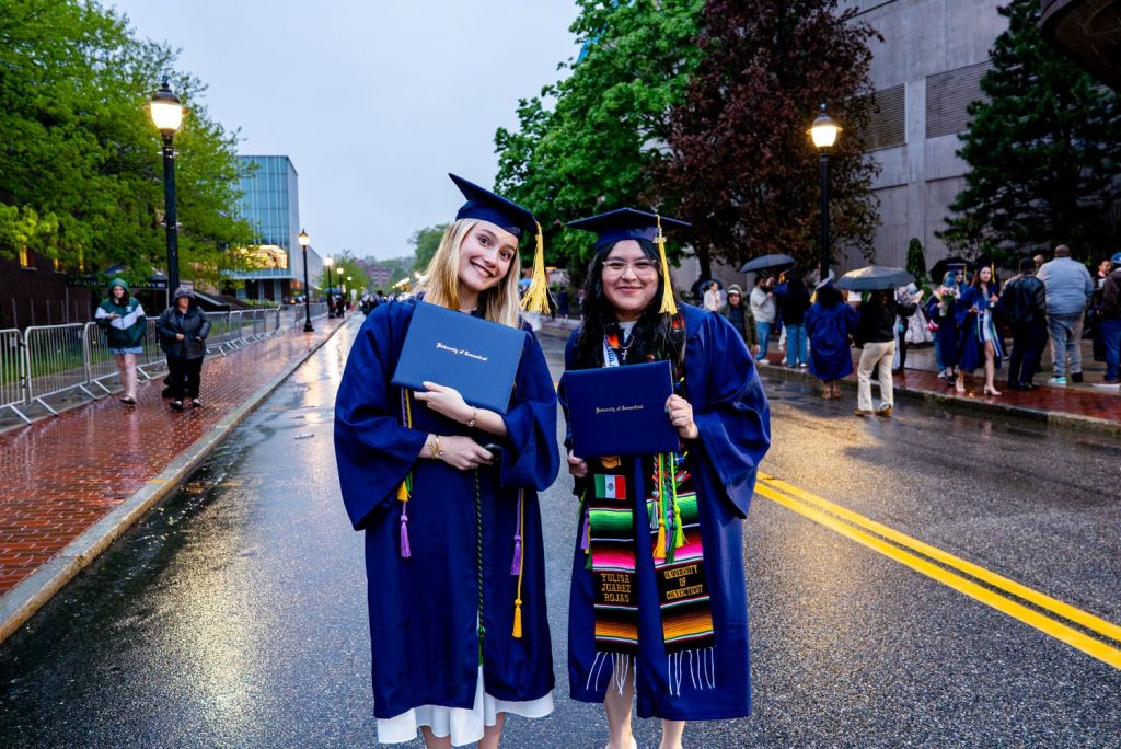 Two CAHNR graduates pose with diplomas