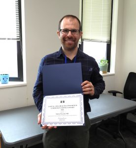 Henry Siccardi holding award