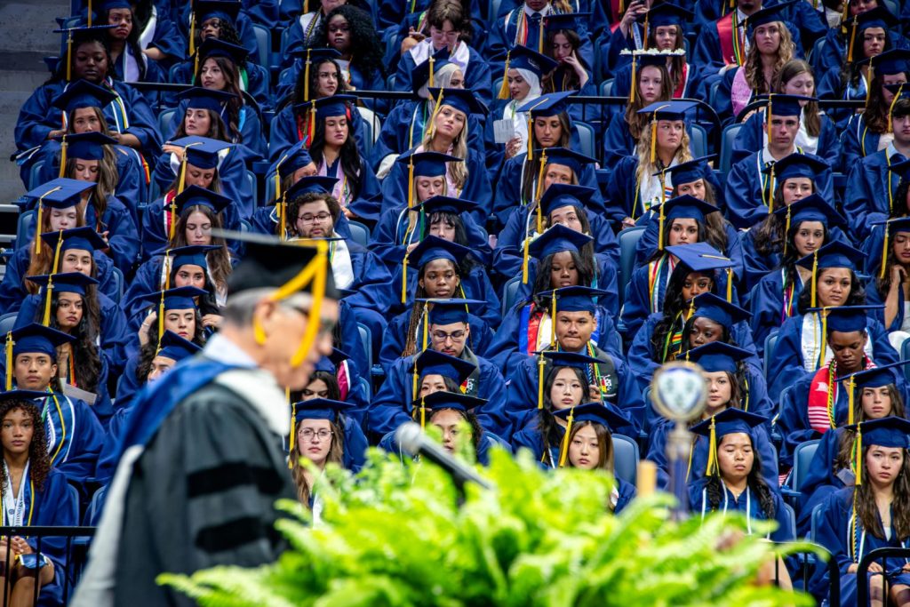 Man speaks at podium in front of CAHNR graduates