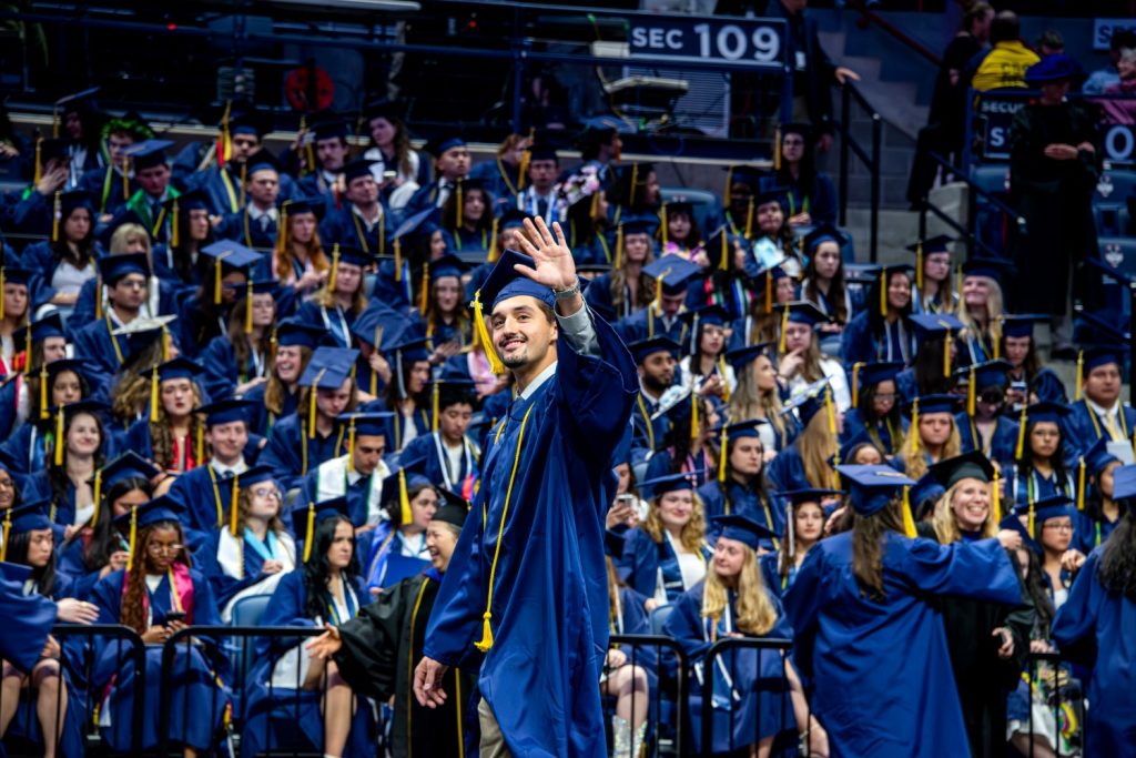 Male student waves to his family at 2026 CAHNR commencement