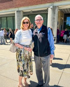 Lori Quinn and Roland Perrault outside smiling