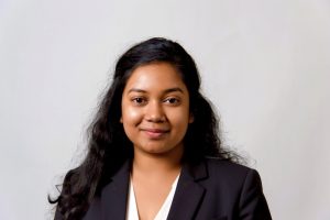 woman in black blazer smiling