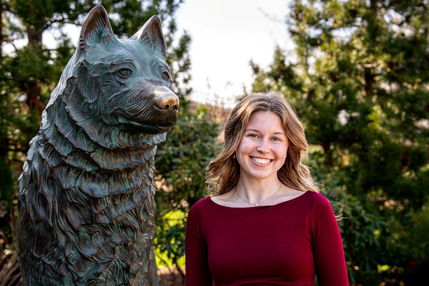 Allyson McCormick ‘26 (CAHNR), an exercise science major poses for a photo next to the Jonathan statue near Harry A. Gampel Pavilion (GAMP
