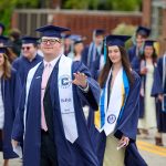 Graduates walk outside.