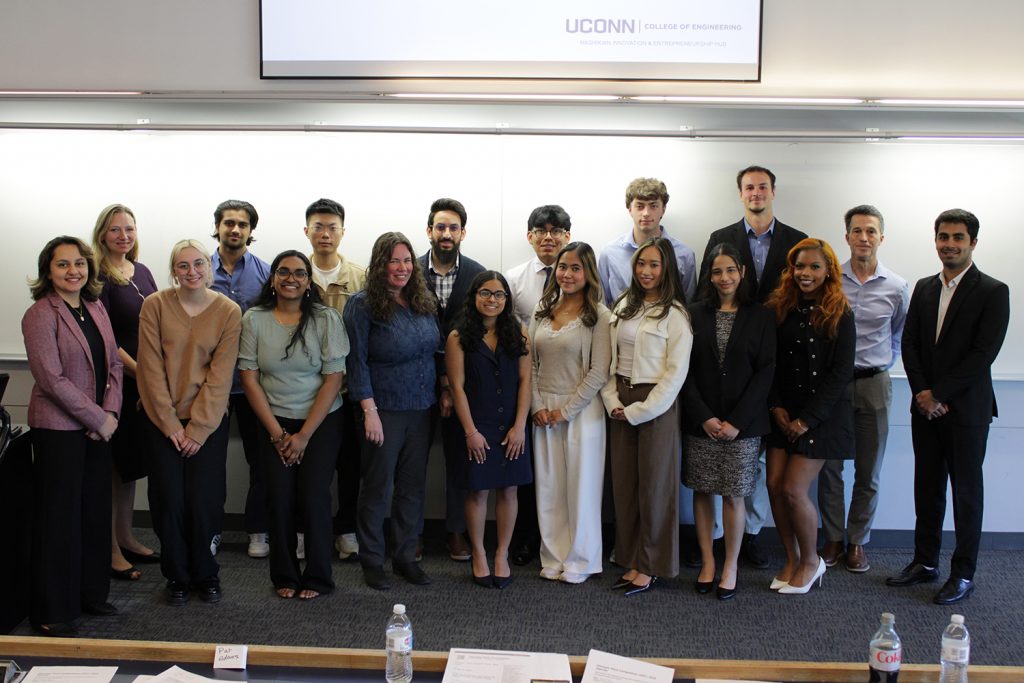 A group photo of students, faculty, and business people.