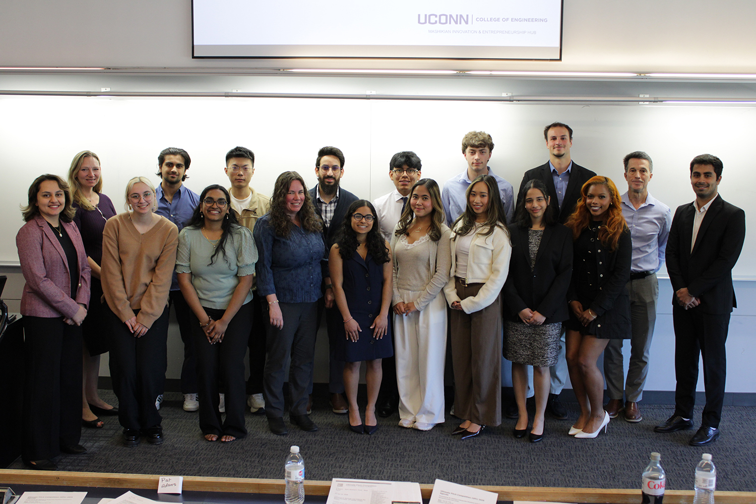 A group photo of students, faculty, and business people.
