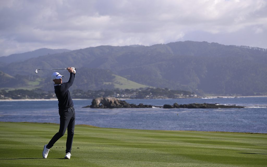A man playing golf at Pebble Beach.