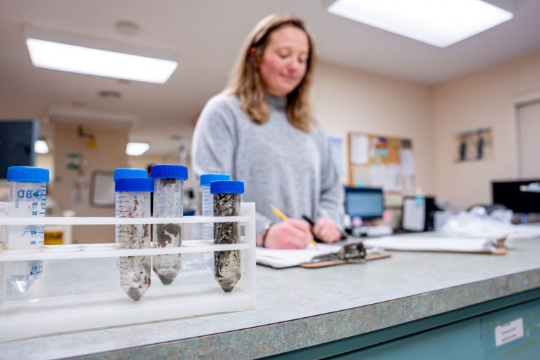 Woman testing samples at UConn Soil Nutrient Analysis Lab