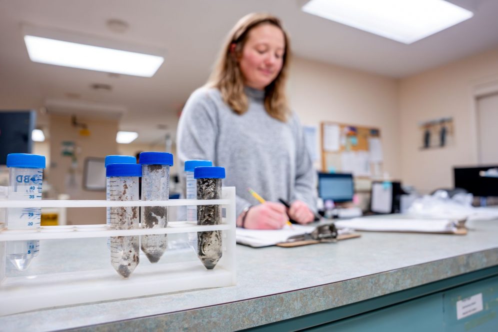 Woman testing samples at UConn Soil Nutrient Analysis Lab