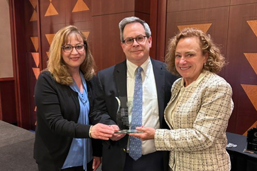 three dentists accepting award