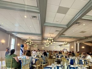a room full of people sitting at tables