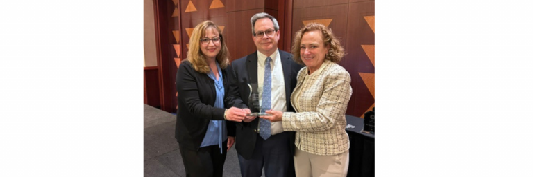 three dentists with award