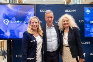 Two women and a man posing for a photo