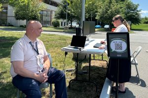 woman standing at outdoor computer station
