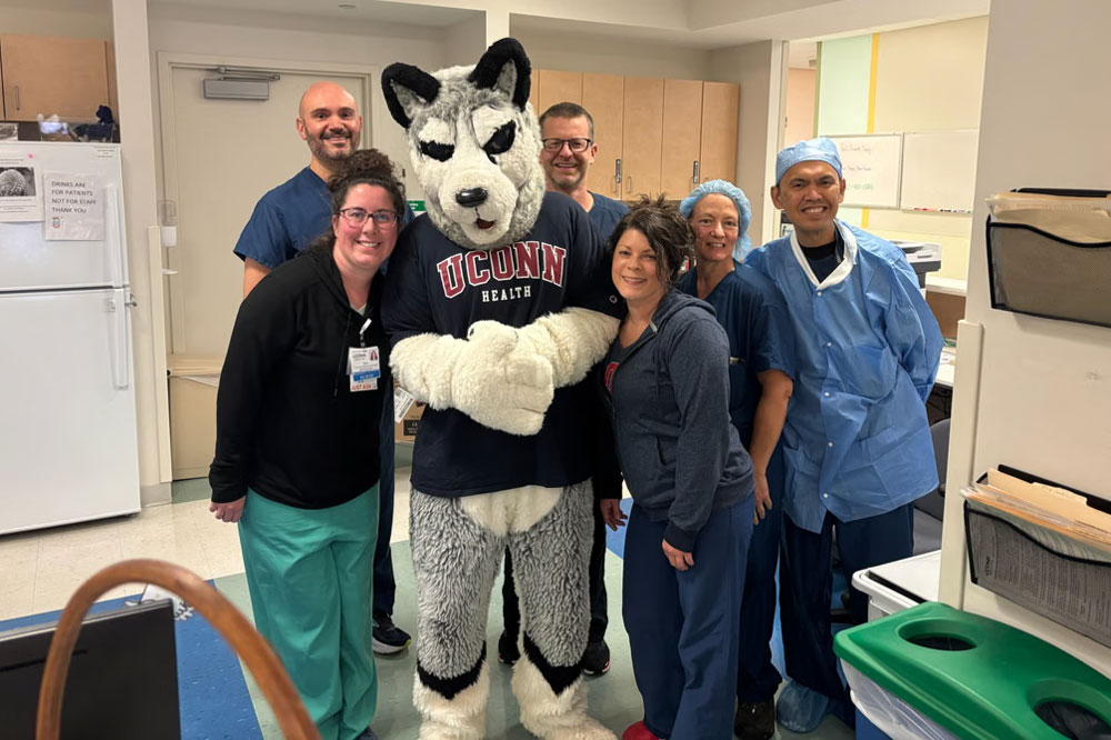 group portrait Husky mascot with 6 staff