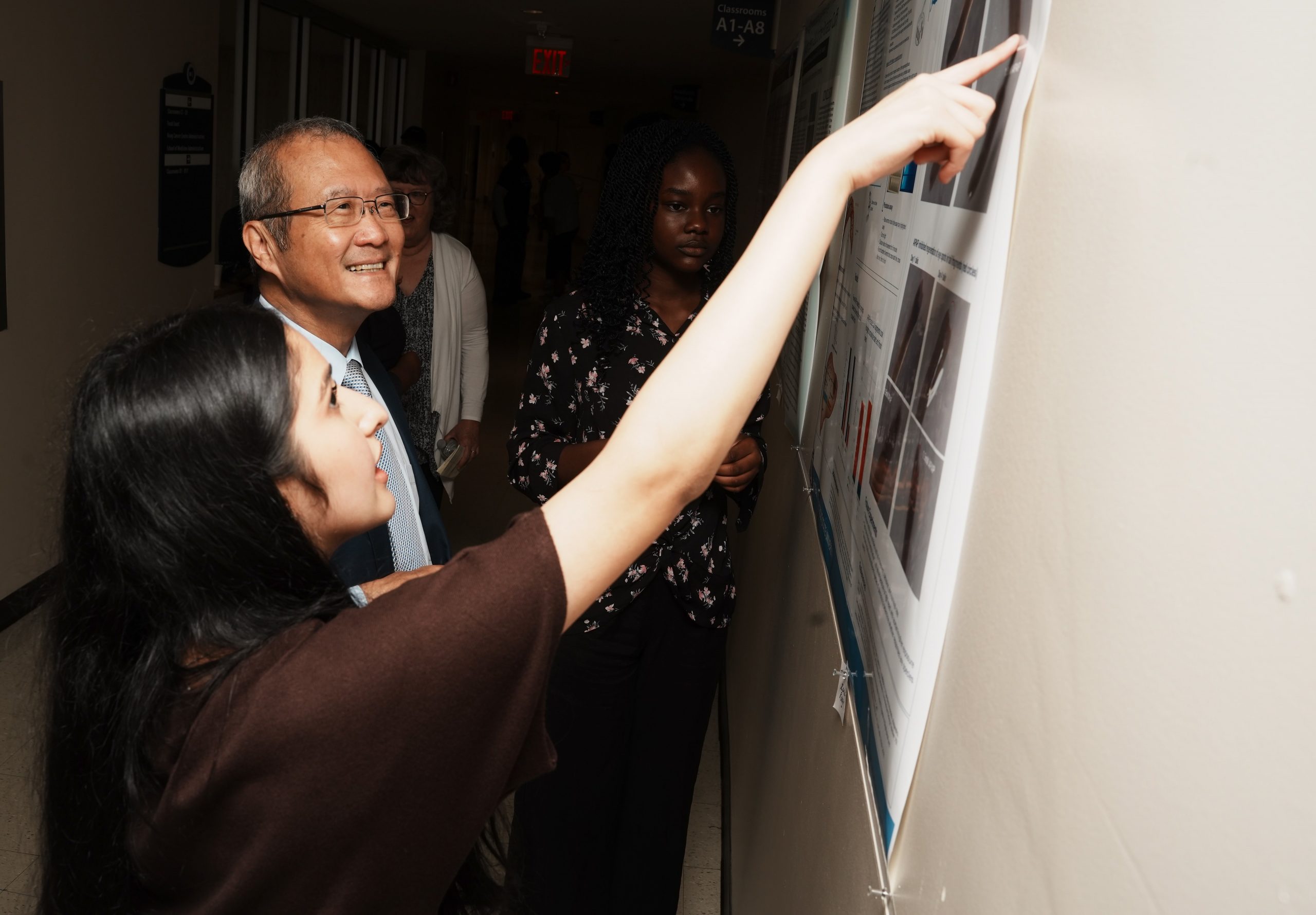 Dean Dr. Bruce T. Liang learning about the high school student research on July 17, 2026 and also shared remarks with the CT youth as a physician-scientists (Photo by John Atashian).