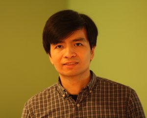 A man in a collared plaid shirt