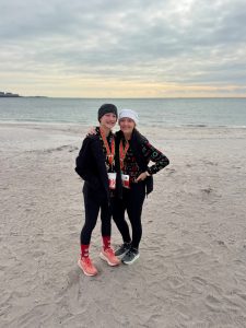 two women standing on the beach