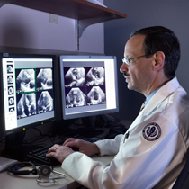 Dr Peter Schulman looking at scans