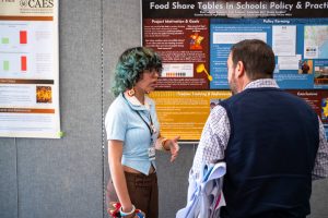 A student presenting a research poster