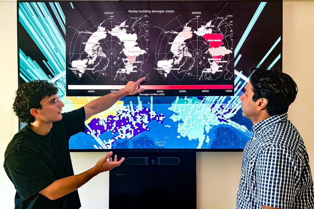 Manos (left) and Witharana (right) looking over Pan-Arctic scale maps of building damage caused by permafrost degradation.