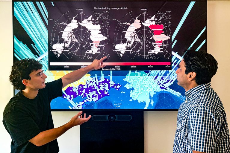 Manos (left) and Witharana (right) looking over Pan-Arctic scale maps of building damage caused by permafrost degradation.