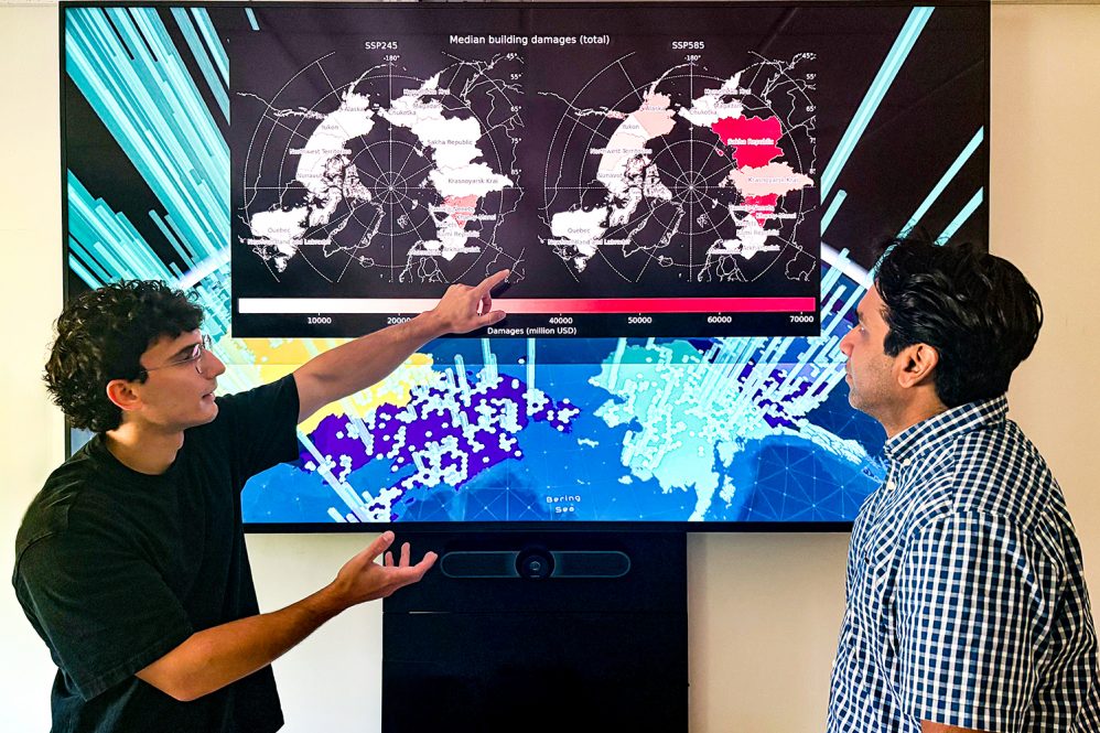 Manos (left) and Witharana (right) looking over Pan-Arctic scale maps of building damage caused by permafrost degradation.