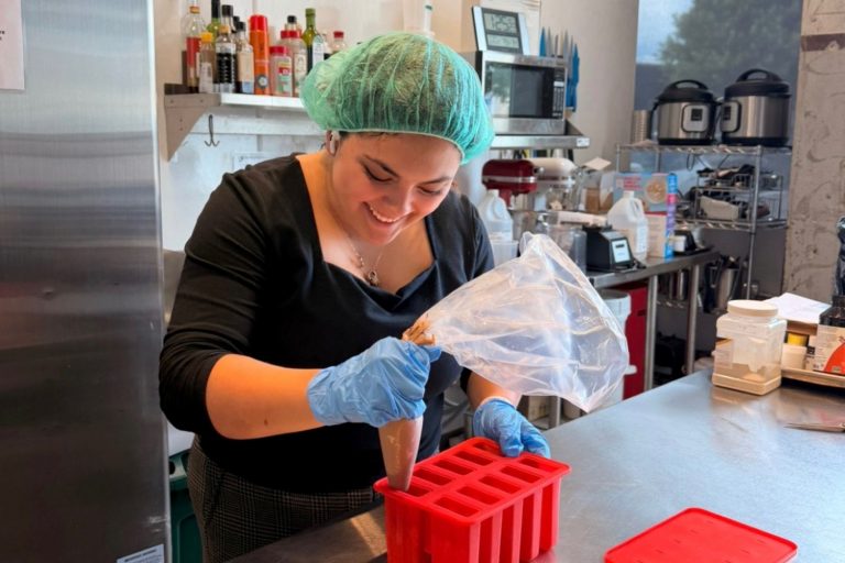 Woman smiling working in an industrial kitchen