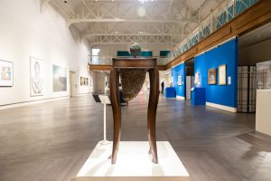 A table and a globe sit on display in a museum