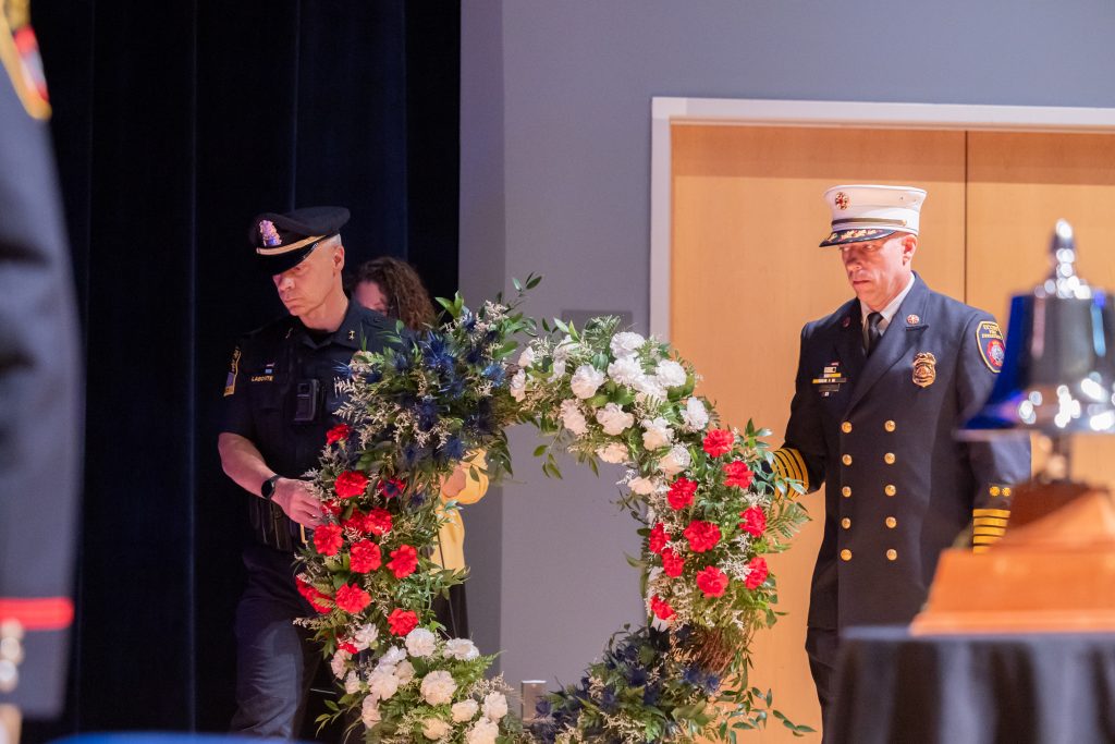 A wreat hwith two men in uniform standing behind it.