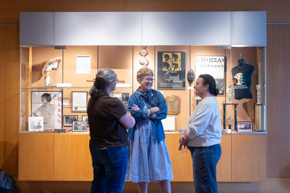 People gather in front of an exhibition