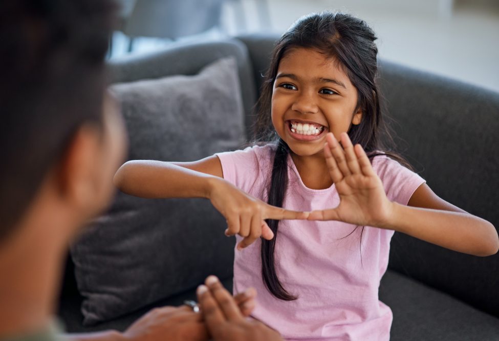 Child, sign language and learning to communicate with deaf girl or parent