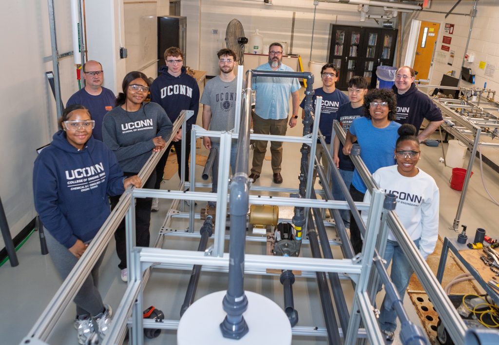 A group photo of the students, faculty, and staff involved in the pipes and pumps experiment.
