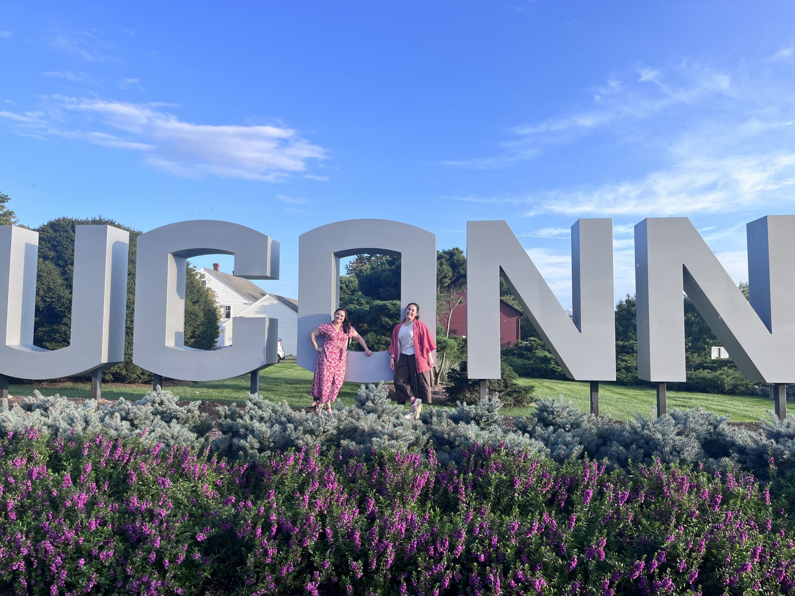 Two DNP students from Chili in front of UConn sign.