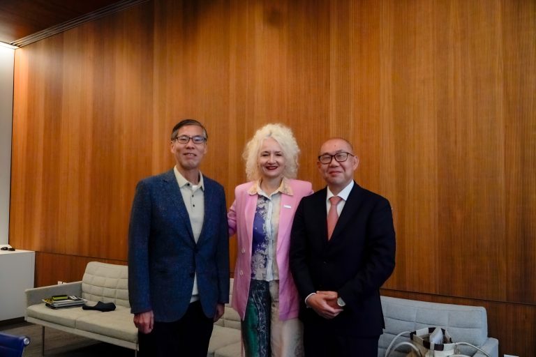 UConn President Radenka Maric and two delegates from Kyoto University pose for a photograph.