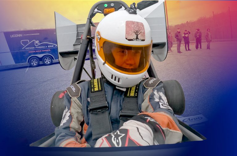 UConn Formula SAE driver seated in a race car during a motorsports testing event.
