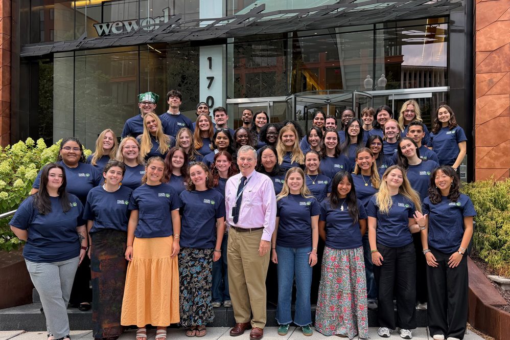 A group of people posing for a photo in blue shirts