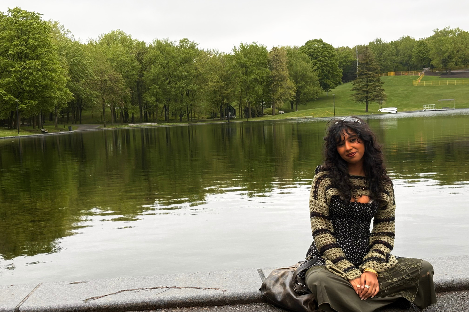 Harri Srivastava poses for a photo next to a lake.