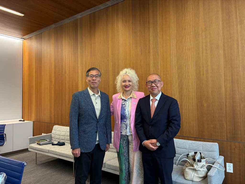 UConn President Radenka Maric stands with two visiting leaders from Kyoto University.