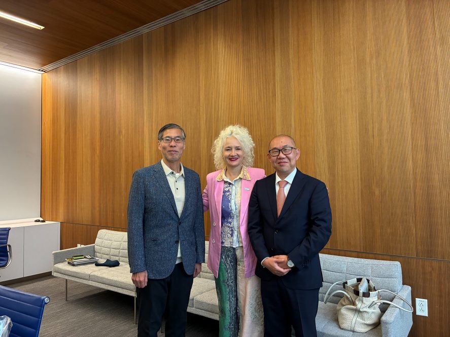 UConn President Radenka Maric stands with two visiting leaders from Kyoto University.