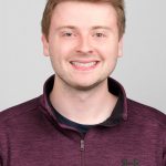 Man smiling in red shirt