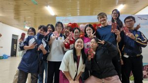 A group of students pose with a teacher.