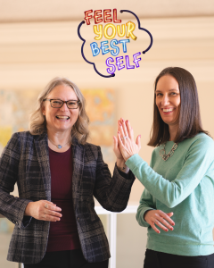 Two women give each other a high five. Above, the words "Feel Your Best Self" appear in colorful text.