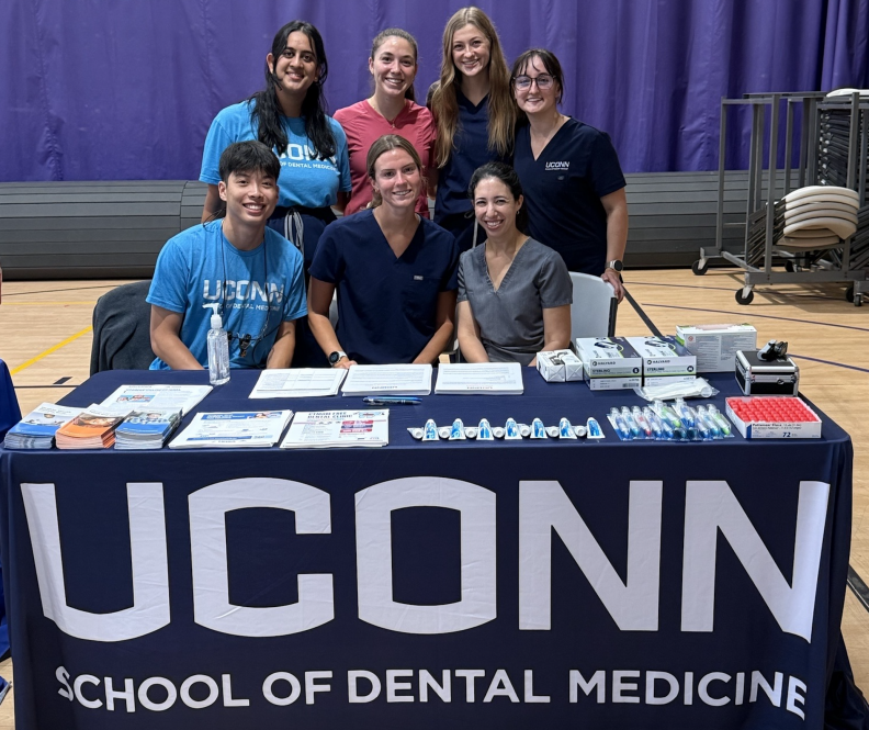 group of students behind booth