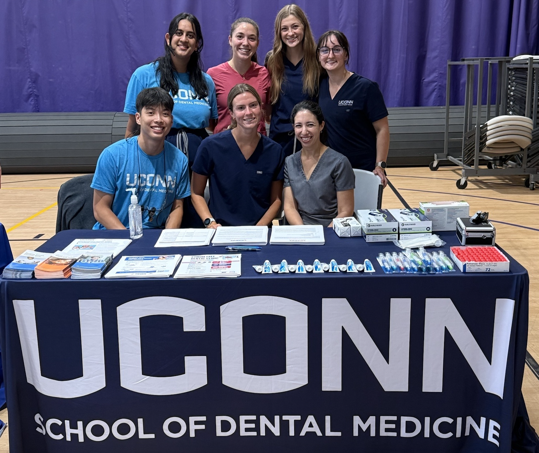 group of students behind booth