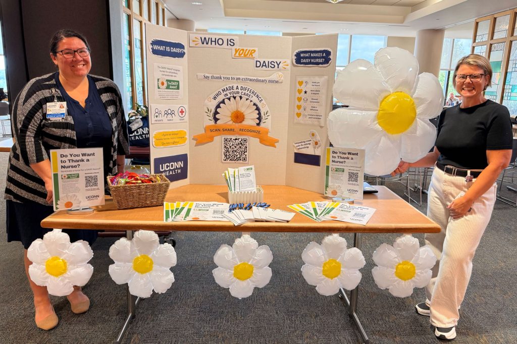 portrait two women at an information table for the DAISY Award for Extraordinary Nurses