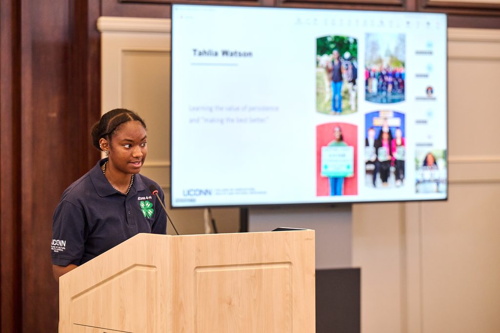 A young woman stands at a podium